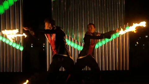 Guys spinning fire sticks Stock Footage