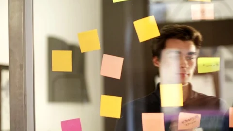Guys stick post-it on the window. Stock Footage 130105288