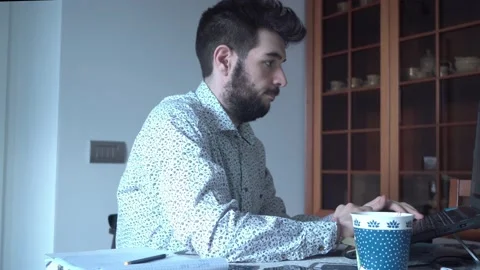 Guys is working hard from hard with the remote tools on his pc Stock Footage 132214140