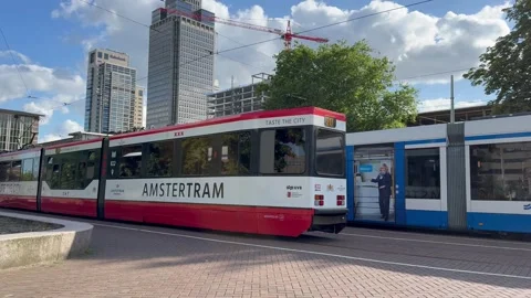GVB tram, tramway arrives at Amsterdam Amstel station stop. Netherlands Stock Footage 341938248