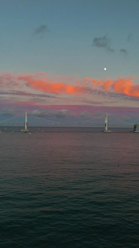 Gwangan bridge at sunset with moon over the sea in busan, south korea Stock Footage 344025779