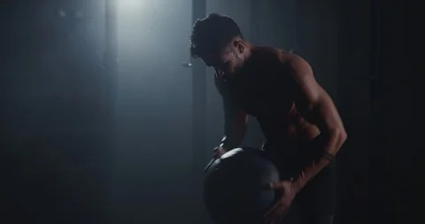 Gym class concept strong athletic guy with a cross fit ball training hard in Stock Footage 125479482