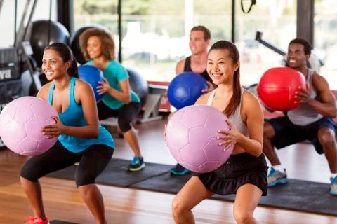 Gym class doing squats Stock Photos