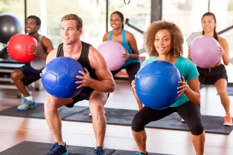 Gym class doing squats Stock Photos