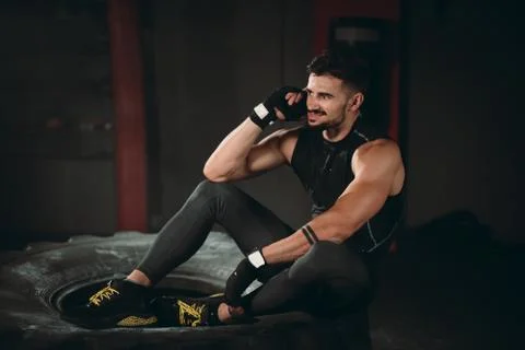In the gym class good looking athletic guy speaking on his phone after a hard Stock Photos