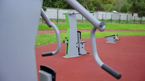 Gym equipment installed on red rubberized sports surface Stock Footage 334683589
