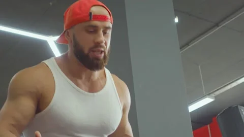 Gym instructor helps athlete to do barbell press on the chest. Sports training Video stock 188681049