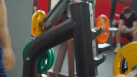 Gym instructor helps athlete to do barbell press on the chest. Sports training 스톡 동영상 188682035