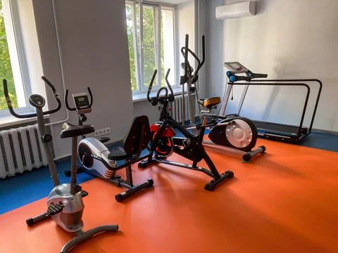 Gym interior with assorted cardiovascular and weight fitness equipment on a.. Stock Photos