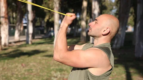 Gym male trainee performs horizontal biceps curls while standing Stock Footage 238762776