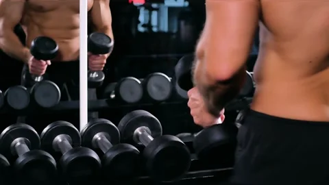 Gym, man doing exercises with dumbbells Stock Footage 248421069