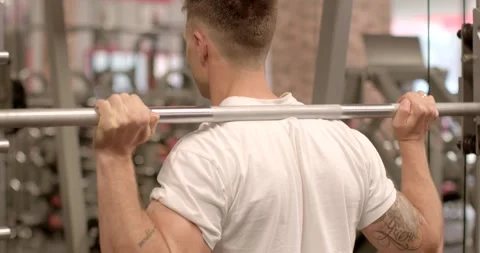 In the gym, man enthusiast is exercising with commitment and determination Stockbeeldmateriaal 280462408