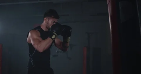 Gym modern class strong and fit guy boxing hard in a punching bag , hard workout Stock-Footage 117051962