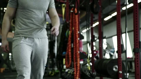 In the gym strong man does exercises on a rowing machine. Stock Footage 88577864