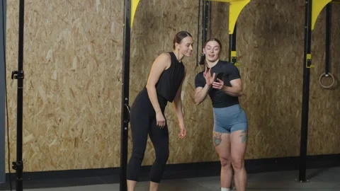 Gym training session captured in slow motion with two athletes Video stock 321399576