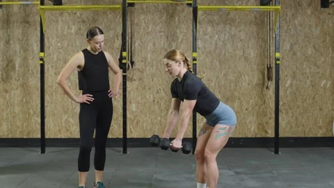 Gym training session showcasing slow motion workout technique with dumbbells Stock Footage 321398577