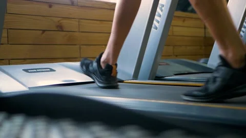 Gym Treadmill walking in slow motion revealing shot of man Stock Footage 148409252