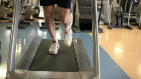 In a gym working out man running on a treadmill Stock Footage
