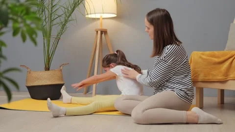 Gym workout with mom. Strength training for kids. Balanced energy in yoga. Young Stockbeeldmateriaal 261302785