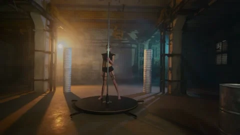 Gymnast dancing at the pole moving her hips and spinning. style cyberpunk Stock Footage 134745978