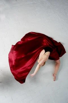 A gymnast in a dark top and a red silk skirt. The color of passion, of Stock Photos