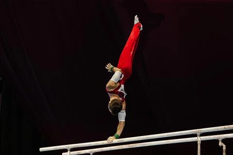 Gymnast exercise on parallel bars competition artistic gymnastics Stock Photos