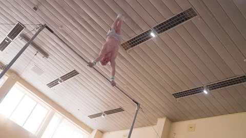 Gymnast exercises high horizontal bar HD slow-motion video. Athlete gymnastics Stock Footage 74728471