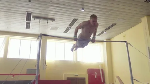 Gymnast exercises on high horizontal bar HD video. Athlete training gymnastics Stock Footage 74728755