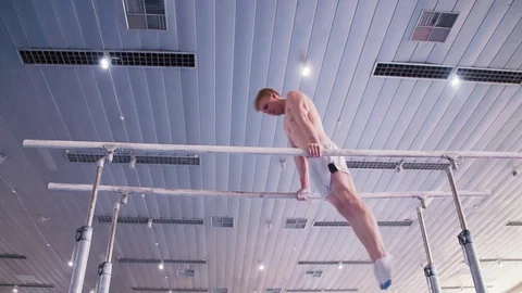Gymnast parallel bars performs HD gymnastics slow-motion video Exercise athlete Stock-Footage 73123577