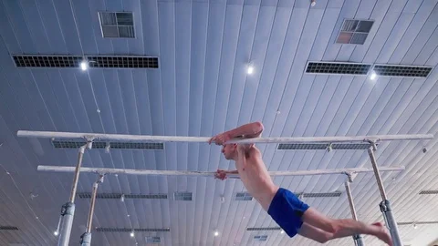 Gymnast parallel bars performs HD gymnastics slow-motion video Exercise athlete Stock Footage 73123602