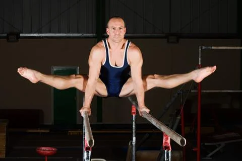 Gymnast on parallel bars Stock Photos