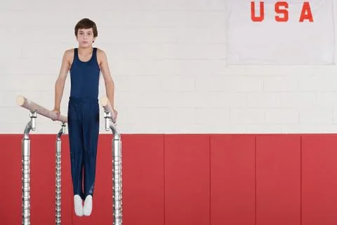 Gymnast on parallel bars Stock Photos