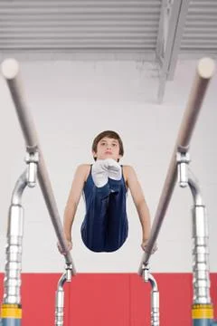 Gymnast on parallel bars Stock Photos