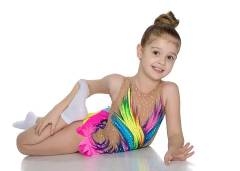 The gymnast perform an acrobatic element on the floor. Stock Photos