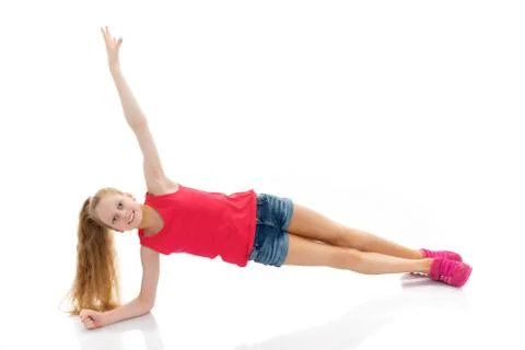 The gymnast perform an acrobatic element on the floor. Stock Photos