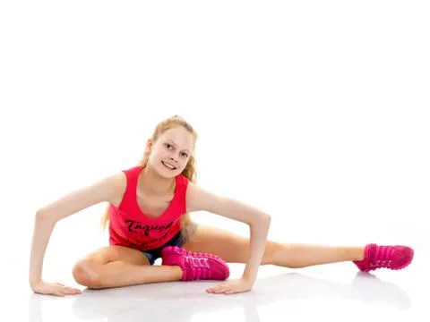 The gymnast perform an acrobatic element on the floor. Stock Photos
