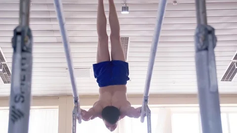 Gymnast performs parallel bars routine HD gymnastics video. Acrobatic exercises Stock Footage 73123986