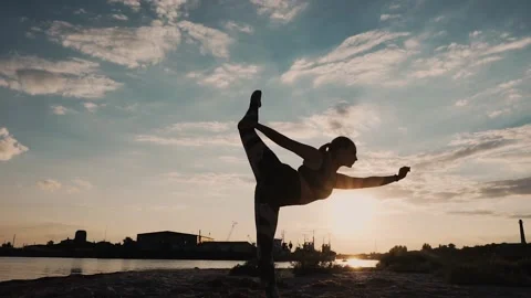 Gymnast Performs Tricks on the Beach Stock Footage 139435030