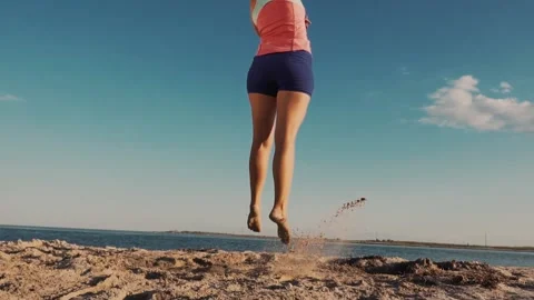 Gymnast Performs Tricks on the Beach Stock Footage 139435044