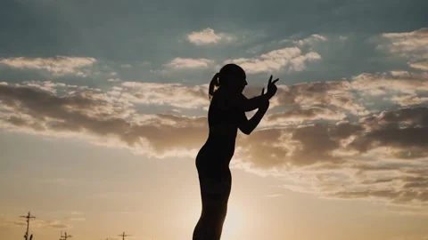 Gymnast Performs Tricks on the Beach Stock Footage 139435099