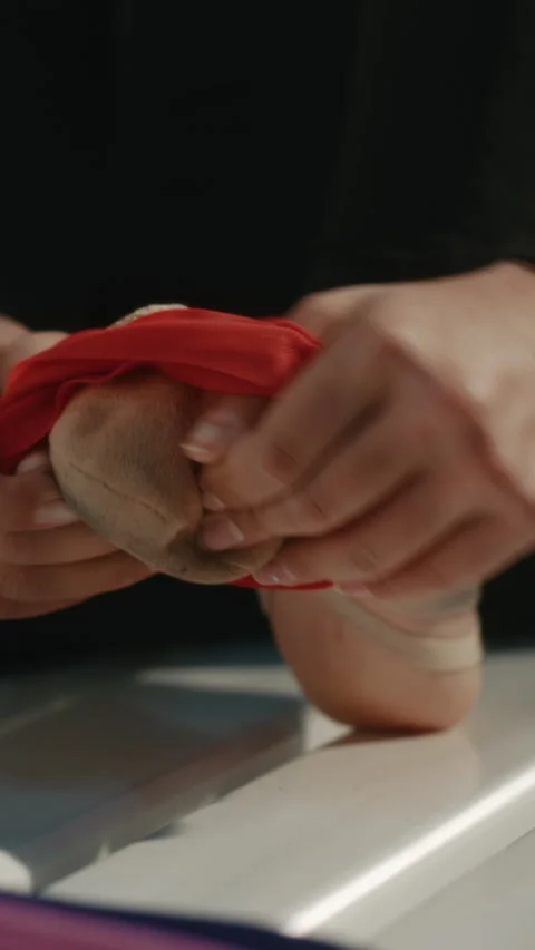 Gymnast Preparing Foot for Training with Elastic Band in Locker Room Stock Footage 339003986