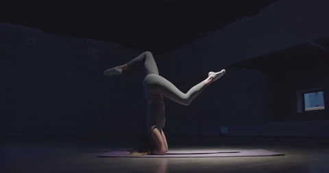 The gymnast stretches while standing on her hands Video stock 156242910