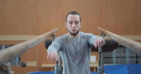 Gymnast training on parallel bars at gym Stock-Footage 104995686