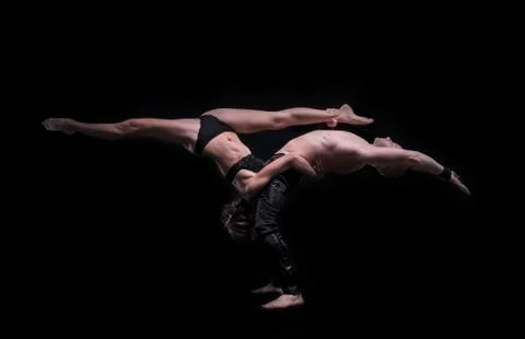 Gymnastic couple performs the element weighs. boy and girl acrobats Stock Photos