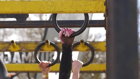 Gymnastic ring traverse executed with muddy hands, slow-mo Video stock 311453384
