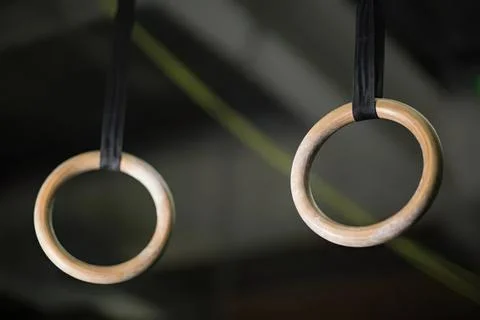 Gymnastic rings hanging from a ceiling for exercise Stock Photos