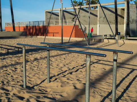 Gymnastics and exercise parallel bars on beach in outdoor gym with men Stock Photos