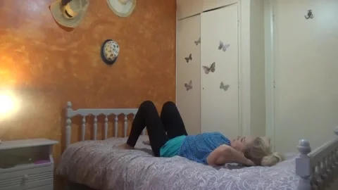 Gymnastics for a flat stomach on the bed Stock Footage 312332078
