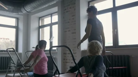 Gymnastics teacher comes up to the learner and corrects him when he performs the 스톡 동영상 102547434