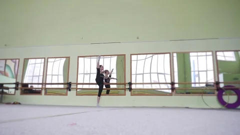 Gymnasts warming up at the mirror. Workout in the gym. Stock Footage 77523129